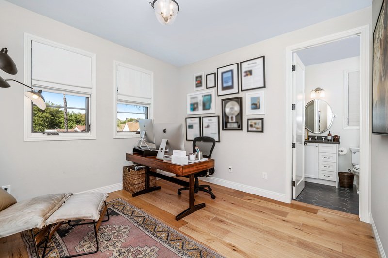Minimalistic desk setup with chair and lamp on the floor